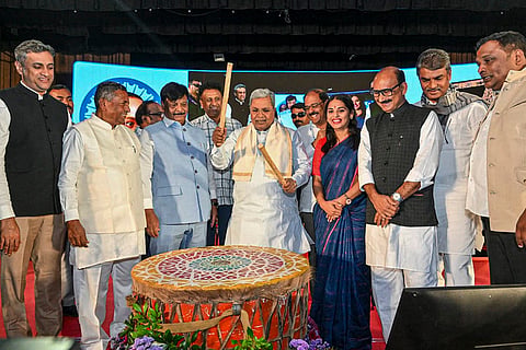 Karnataka Chief Minister Siddaramaiah tries his hands on a traditional drum during an event on the Constitution Day, in Bengaluru. 