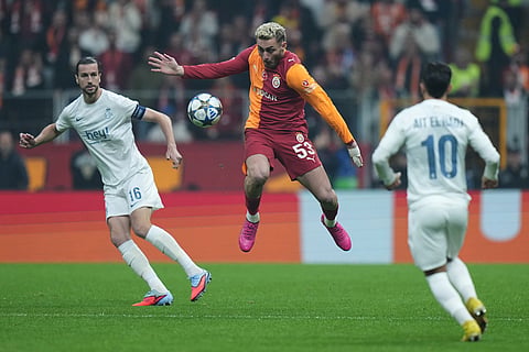 Galatasaray's Baris Yilmaz, center, fights for the ball during the Champions League opening phase soccer match between Galatasaray and Union Saint-Gilloise, in Istanbul, Turkey.
