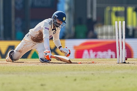 India's Ravindra Jadeja dives to reach the crease after stumped out on the fifth day of the second cricket test match between India and South Africa in Guwahati.