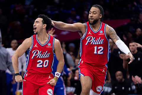Philadelphia 76ers' Jared McCain (20) celebrates his three-point shot with Trendon Watford (12) during the first half of an NBA Cup basketball game against the Orlando Magic in Philadelphia.
