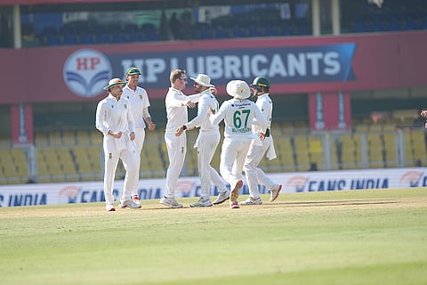 South Africa's Simon Harmer with teammates celebrates the wicket of India's Kuldeep Yadav during the fifth day of the second Test cricket match between India and South Africa, at ACA Stadium, Barsapara in Guwahati.