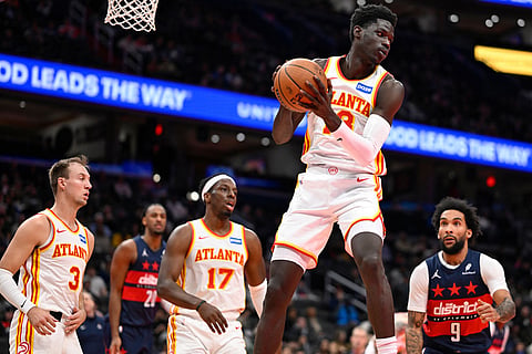 Atlanta Hawks forward Mouhamed Gueye grabs a rebound during the first half of an NBA Cup basketball game against the Washington Wizards in Washington.