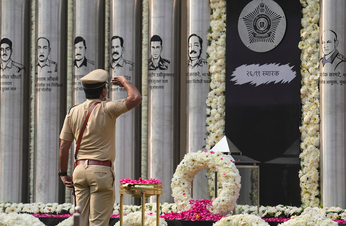 PTI  :  A police official pays tribute to the martyrs of 26/11 Mumbai terror attack during a programme marking the 17th anniversary of the attack.