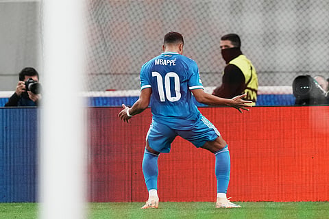 Real Madrid's Kylian Mbappe celebrates scoring his side's 3rd goal during the Champions League opening phase soccer match between Olympiacos and Real Madrid in Piraeus port, near Athens, Greece.