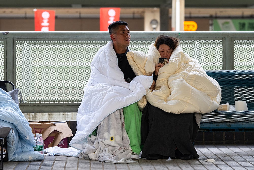 Hong Kong high-rise blaze in Tai Po-Residents rest at the fire scene