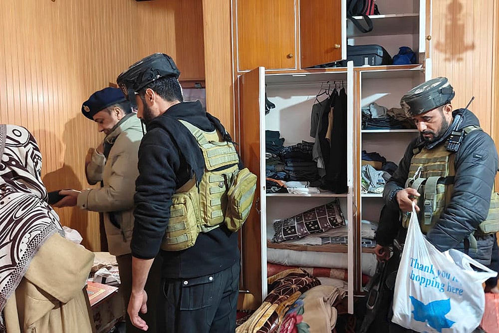 | Photo: PTI  : Police with CRPF personnel carry out a search at the residence of a person linked to banned Jamaat-e-Islami, in Pulwama. J&K Police carried out raids at multiple locations across the Kashmir Valley as part of its crackdown on the banned Jamaat-e-Islami (JeI), officials said. 