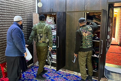 Police personnel carry out a raid at the residence of a person linked to the banned Jamaat-e-Islami (JeI) organisation, in Anantnag.
