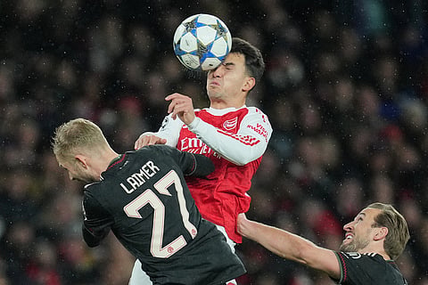 Arsenal's Martin Zubimendi, center, is challenged by Bayern's Konrad Laimer and Harry Kane during the Champions League opening phase soccer match between Arsenal and Bayern Munich in London.