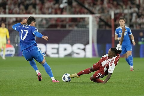 Olympiacos' Gelson Martins, right, challenges for the ball with Real Madrid's Raul Asencio during the Champions League opening phase soccer match between Olympiacos and Real Madrid, in in Piraeus port, near Athens, Greece.