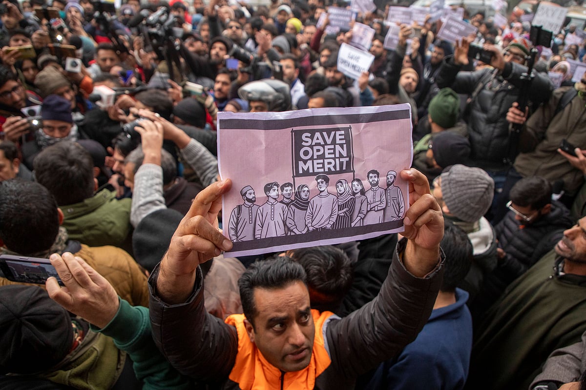 ZUMA Wire : A Kashmiri man holds a placard during a protest outside the chief minister’s official residence in Srinagar against Jammu and Kashmir’s reservation policy.
