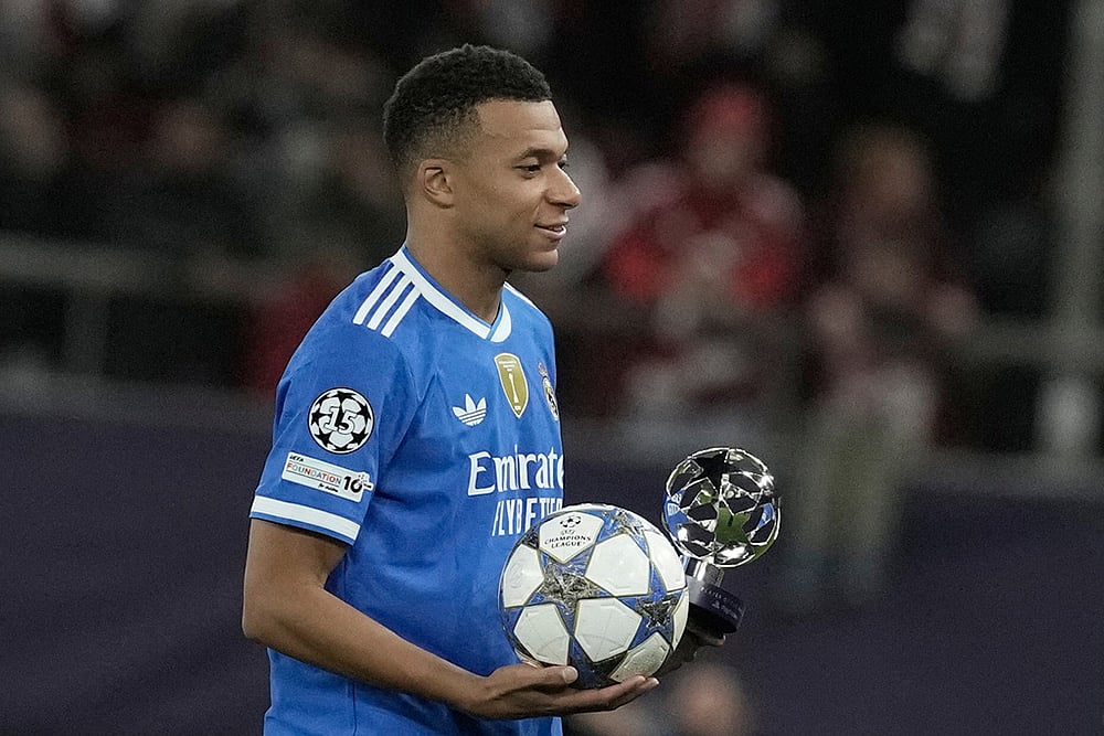 | Photo: AP/Petros Giannakouris : Real Madrid's Kylian Mbappe poses with the trophy after scoring four goal during the Champions League opening phase soccer match between Olympiacos and Real Madrid, in in Piraeus port, near Athens, Greece.