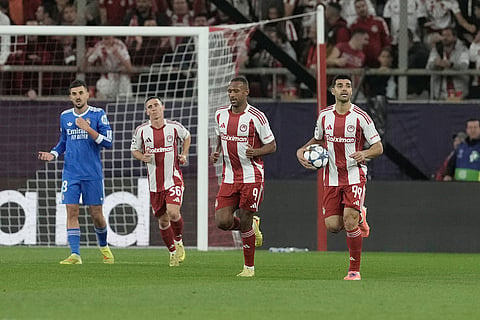 Olympiacos' Mehdi Taremi, right, reacts after scoring his side's second goal during the Champions League opening phase soccer match between Olympiacos and Real Madrid, in in Piraeus port, near Athens, Greece.