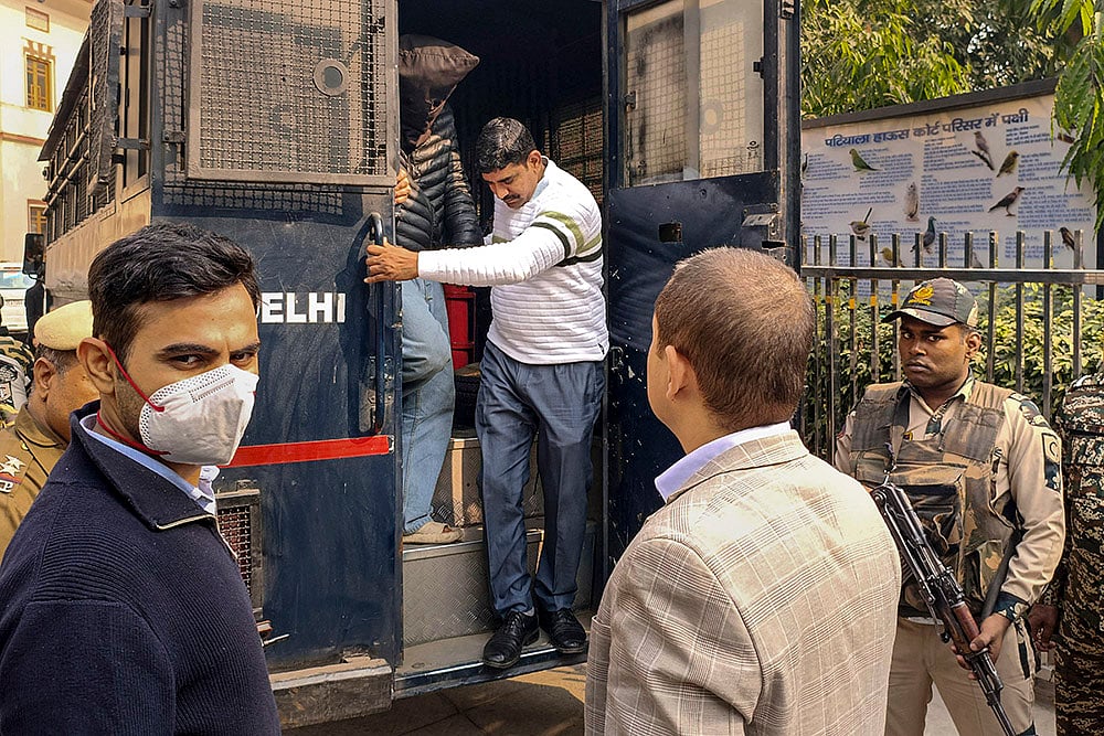 | Photo: PTI : Jasir Bilal Wani, face covered, a key accused in the Red Fort blast case, while being produced at the Patiala House Court, in New Delhi. The Delhi court on Thursday sent Wani to the National Investigating Agency's custody for seven days. 