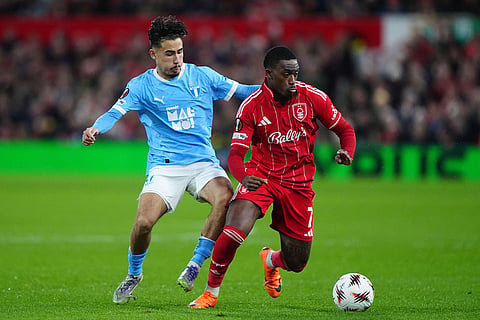 Malmo's Adrian Skogmar, left, and Nottingham Forest's Callum Hudson-Odoi battle for the ball during the Europa League opening league phase soccer match between Nottingham Forest and Malmo FF in Nottingham, England.