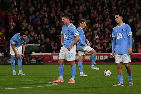 Malmo's Lasse Berg Johnsen, left and Malmo's Adrian Skogmar react after Nottingham Forest's Arnaud Kalimuendo scored his sides second goal of the games the Europa League opening phase soccer match between Nottingham Forest and Malmo in Nottingham, England.