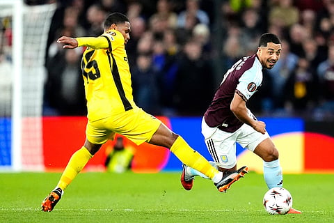 Aston Villa's Youri Tielemans, right, and Young Boys' Rayan Raveloson, left, challenge for the ball during the Europa League soccer match between Aston Villa and Young Boys in Birmingham, England.