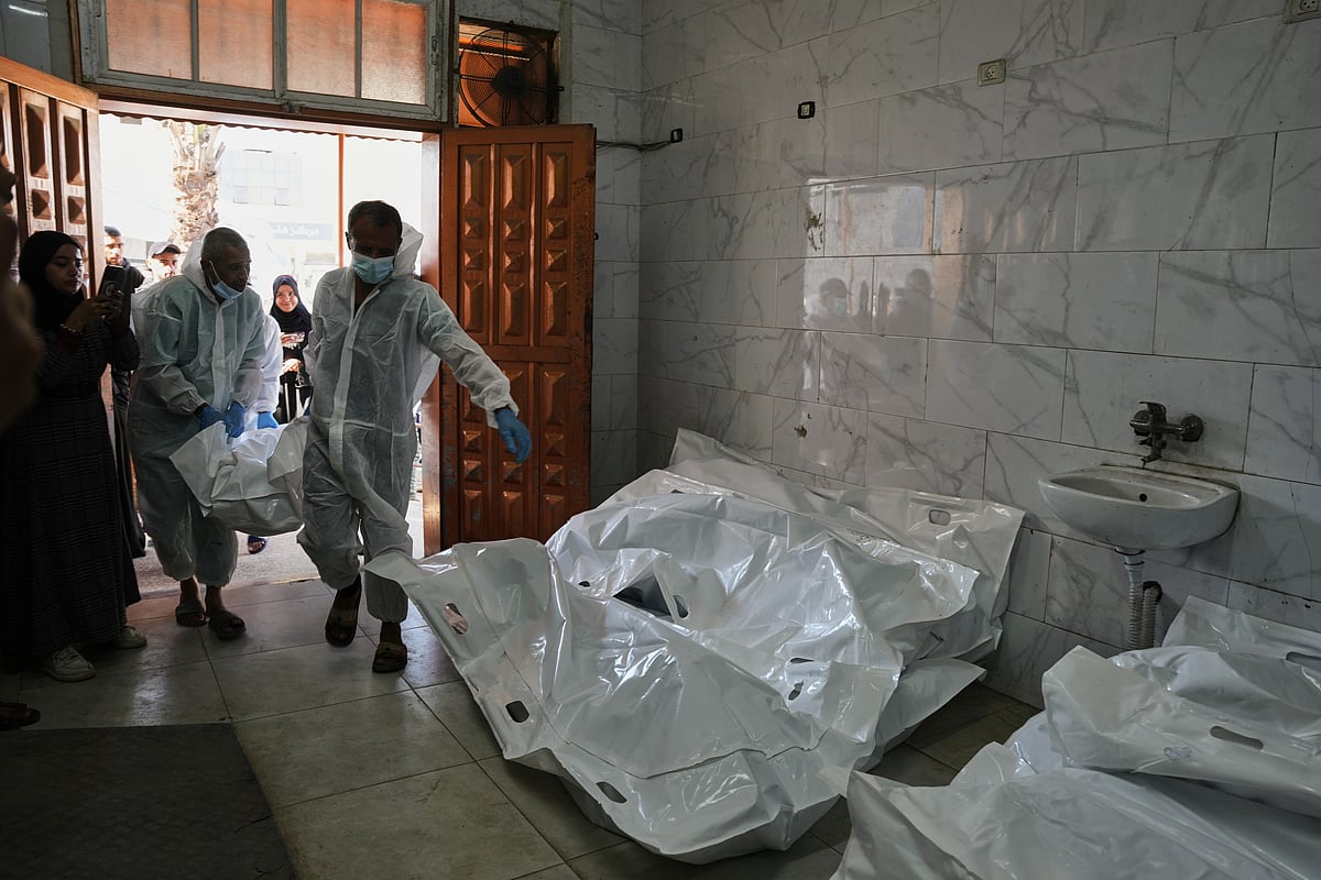 AP Photo/ Abdel Kareem Hana : Bodies of unidentified Palestinians returned from Israel as part of the ceasefire deal are brought to Nasser Hospital in Khan Younis, Gaza Strip, Wednesday, Nov. 26, 2025. 