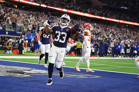 Dallas Cowboys running back Javonte Williams (33) celebrates after scoring during the second half of an NFL football game against the Kansas City Chiefs in Arlington, Texas. 
