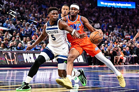 Oklahoma City Thunder guard Shai Gilgeous-Alexander (2) drives against Minnesota Timberwolves guard Anthony Edwards (5) during the first half of an Emirates NBA Cup basketball game in Oklahoma City. 