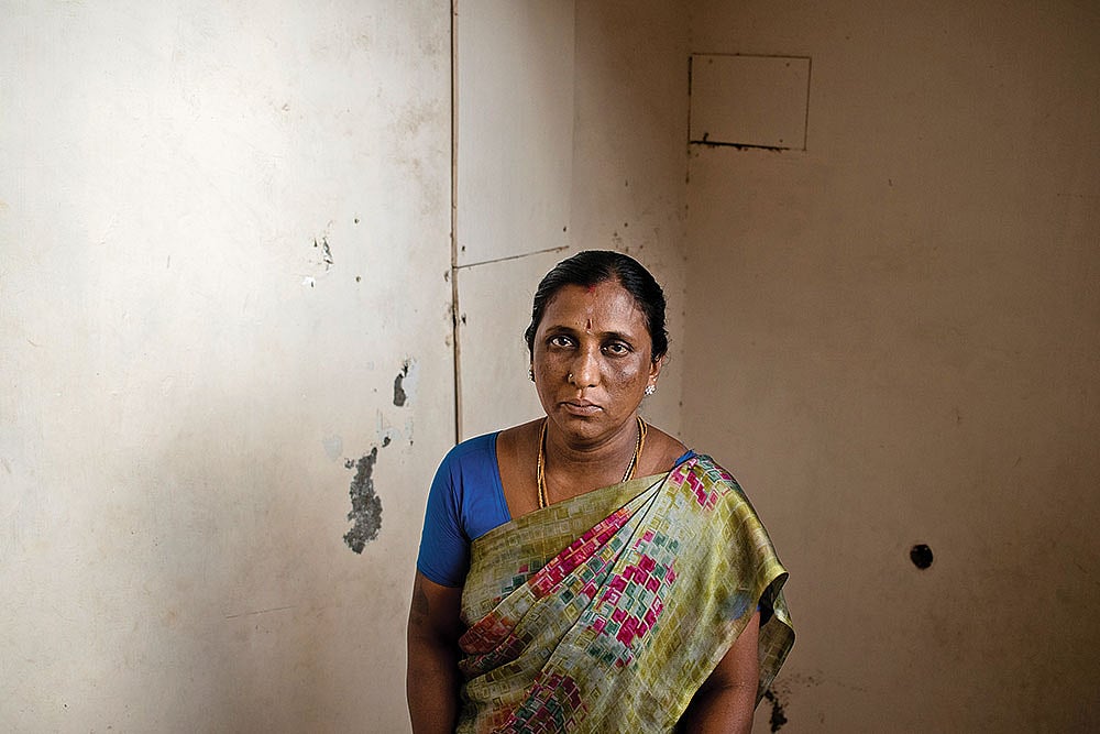 Muthu, who lives in a Dalit colony near Madurai, in front of his dilapidated house