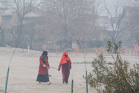 People walk through the Eidgah ground on a cold winter morning, in Srinagar. Kashmir is experiencing its coldest November since 2007, with minimum temperatures dipping below the freezing point across several locations, officials said on Friday. 
