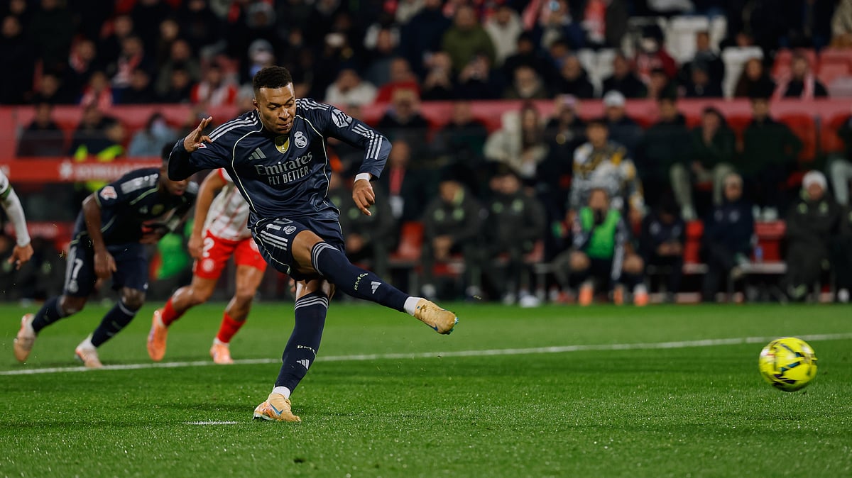 | Photo: AP/Joan Monfort : Real Madrid's Kylian Mbappe scores a penalty kick during a Spanish La Liga match against Girona on November 30, 2025.