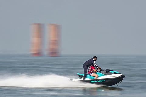 People enjoy a water sports ride at Juhu Beach, in Mumbai.