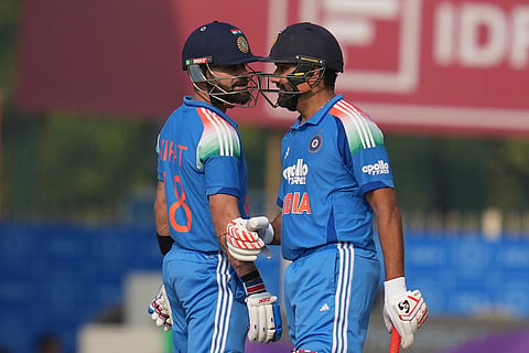 India's Virat Kohli, left, and India's Rohit Sharma chat during the first One Day International match between India and South Africa in Ranchi.