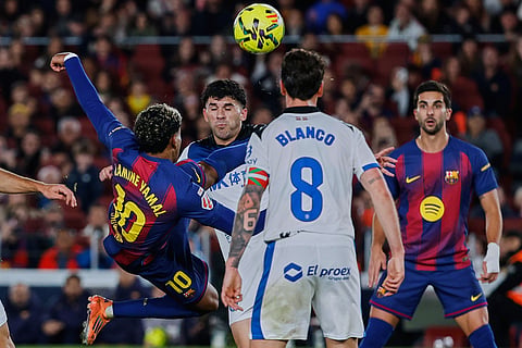 Barcelona's Lamine Yamal tries a shot during a Spanish La Liga soccer match between Barcelona and Alaves, in Barcelona, Spain.