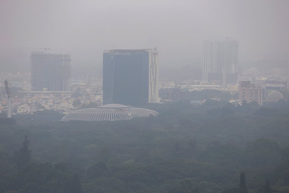 | Photo: PTI : An aerial view of the city under cloudy skies, in Bengaluru. The weather remains affected as Cyclone Ditwah influences conditions across neighbouring states. 