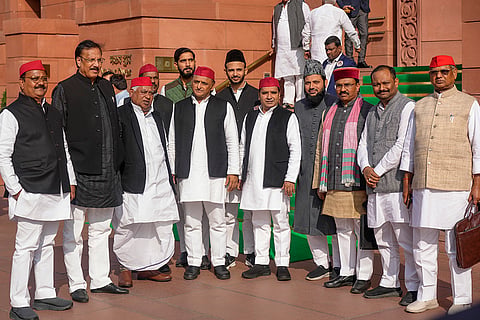 Samajwadi Party President Akhilesh Yadav with party leaders outside the Parliament on the first day of the Winter Session, in New Delhi.