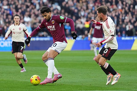 West Ham's Lucas Paqueta, left, is challenged by Liverpool's Alexis Mac Allister during the English Premier League soccer match between West Ham United and Liverpool, in London.