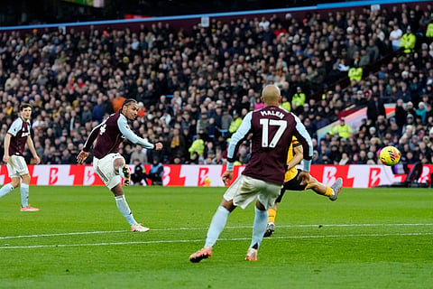Aston Villa's Boubacar Kamara, second left, scores his side's first goal, during the English Premier League soccer match between Aston Villa and Wolverhampton Wanderers, at Villa Park, in Birmingham, England.