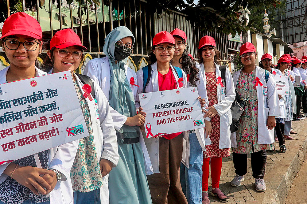 | Photo: PTI : Students form a human chain during an awareness rally on World AIDS Day, in Bhopal.