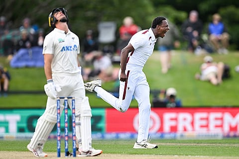 West Indies bowler Johann Layne, right, celebrates the wicket of New Zealand's Will Young, left, during their cricket test match in Christchurch, New Zealand.