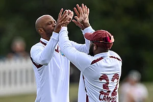 | Photo: John Davidson/Photosport via AP : West Indies' Roston Chase, left, and teammate John Campbell celebrate after taking the wicket of New Zealand's Nathan Smith during their cricket test match in Christchurch, New Zealand.