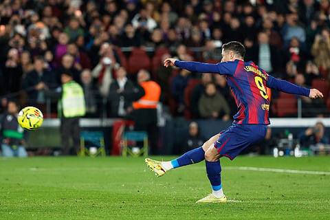 Barcelona's Robert Lewandowski takes a penalty kick during a Spanish La Liga soccer match between Barcelona and Atletico de Madrid, in Barcelona, Spain.