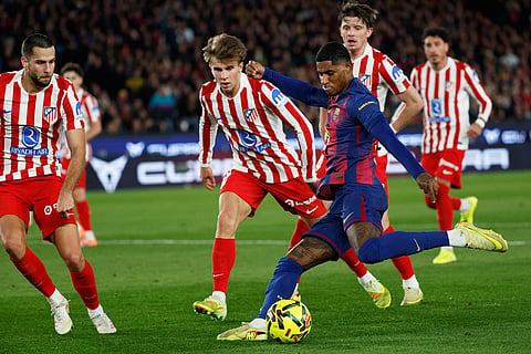 Barcelona's Marcus Rashford fights for the ball against Atletico Madrid's Pablo Barrios during a Spanish La Liga soccer match between Barcelona and Atletico de Madrid, in Barcelona, Spain.