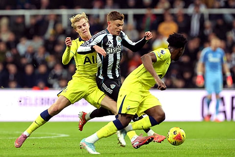 Tottenham Hotspur's Lucas Bergvall, left, and Newcastle United's Harvey Barnes battle for the ball during their English Premier League soccer match in Newcastle, England.