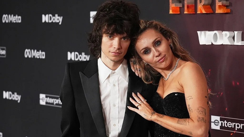 AP Photo/Chris Pizzello : Singer Miley Cyrus, right, poses for photographers with her boyfriend Maxx Morando at the premiere of the film "Avatar: Fire and Ash" on Monday, Dec. 1, 2025, at Dolby Theatre in Los Angeles.