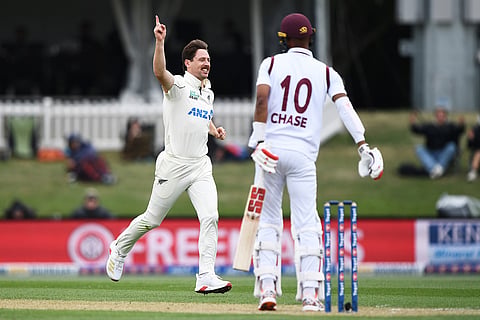 New Zealand's Matt Henry, left, celebrates after the wicket of West Indies' batter Roston Chase, right, during the second day of their cricket test match in Christchurch, New Zealand.