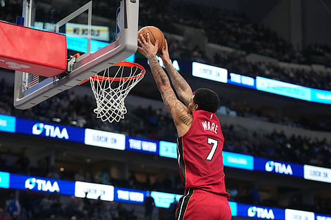Miami Heat center Kel'el Ware scores a basket on the Dallas Mavericks during the second half of an NBA basketball game in Dallas. 