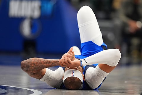 Dallas Mavericks forward Daniel Gafford reacts after a play against the Miami Heat during the second half of an NBA basketball game in Dallas.