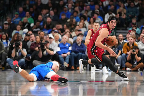 Miami Heat forward Jaime Jaquez Jr., right, steals the ball from Dallas Mavericks forward Cooper Flagg, left, during the second half of an NBA basketball game in Dallas. 