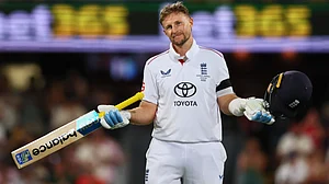 AP Photo/Tertius Pickard : England's Joe Root celebrates his century during the second Ashes cricket test match between Australia and England in Brisbane, Thursday, Dec. 4, 2025.
