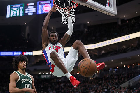 Detroit Pistons' Paul Reed dunks against Milwaukee Bucks' Jericho Sims during the second half of an NBA basketball game in Milwaukee.