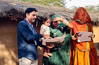 Outlook Explains | Karnataka Begins SIR: What Does The Door-to-Door Voter Verification Mean For You? | Photo: PTI : A booth level officer (BLO) assists voters in filling out enumeration forms for the special intensive revision (SIR) of electoral rolls, in Bikaner, Rajasthan.