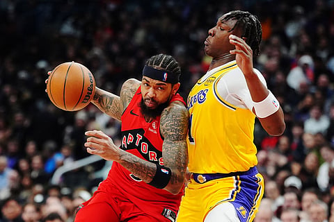 Toronto Raptors' Brandon Ingram (3) drives at Los Angeles Lakers' Adou Thiero (1) during first half NBA basketball action in Toronto.