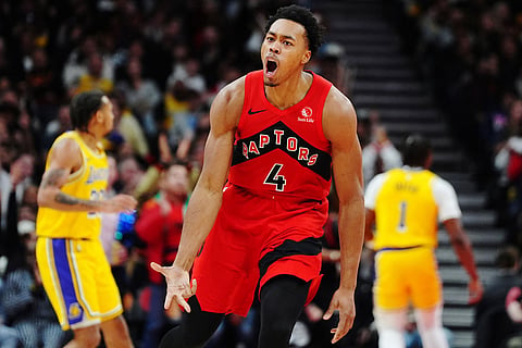 Toronto Raptors' Scottie Barnes (4) celebrates after a basket against the Los Angeles Lakers during second-half NBA basketball game action in Toronto.