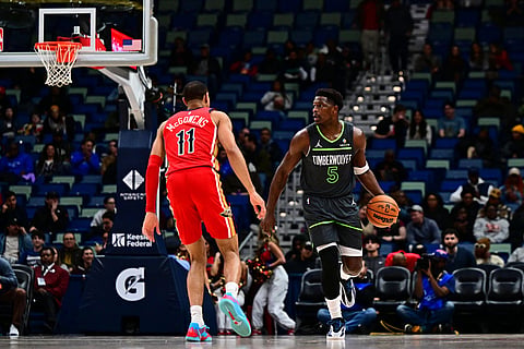 Minnesota Timberwolves guard Anthony Edwards (5) drives with the ball against New Orleans Pelicans guard Bryce McGowens (11) in the first half of an NBA basketball game in New Orleans.